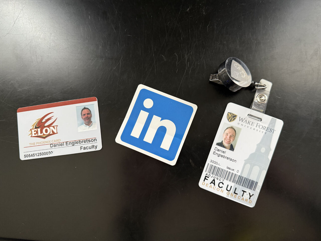 University faculty credentials and a published-course badge laid on a desk